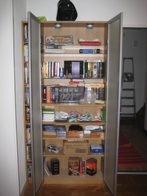 Bookcase with DVDs and some games.