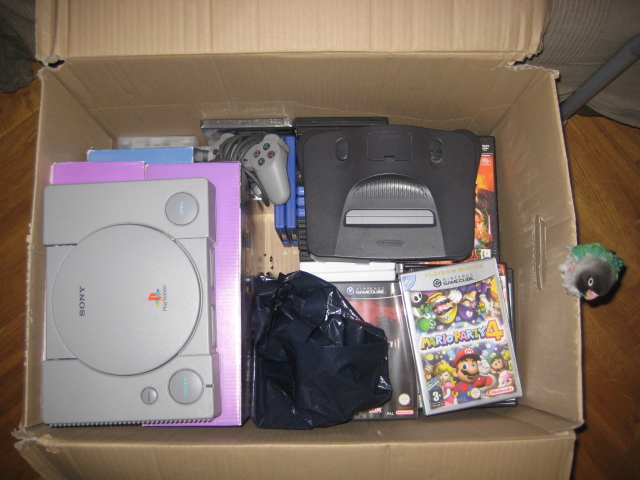 A box o' games with a N64 and broken PS1... and a parrot