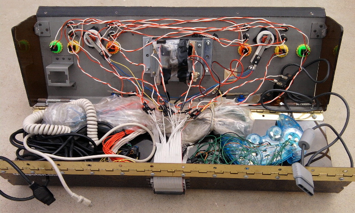 LOTTA WIRES. RIGHT SIDE ABOVE BLUE PS1 CONTROLLER, MICRO SWITCH ADDED FOR THE COIN REJECT DROP BUTTON.