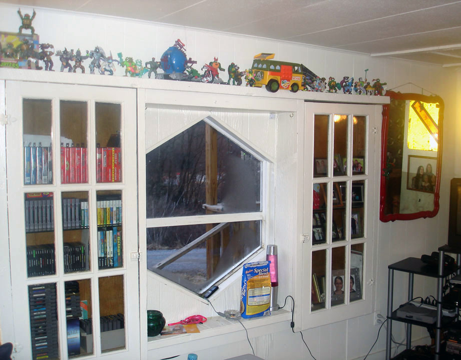 I keep all my games in the left glass cabinet. On top are old school TMNT figures.